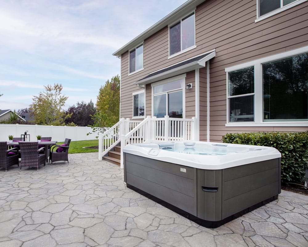 Un spa Bullfrog de la série X, mettant en valeur son design contemporain et sa fonctionnalité dans une belle maison